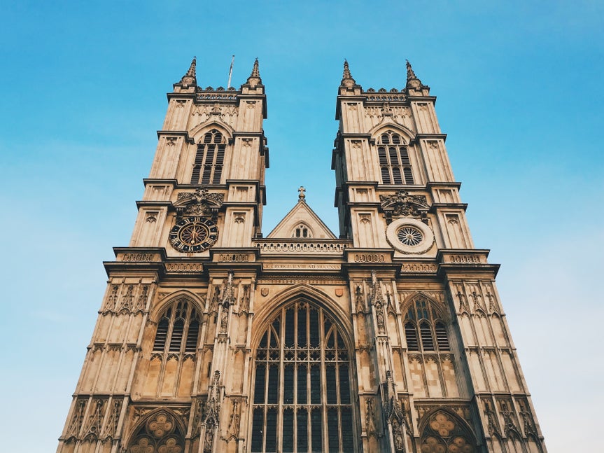 Original photo of gothic cathedral with warm lighting and clear blue sky