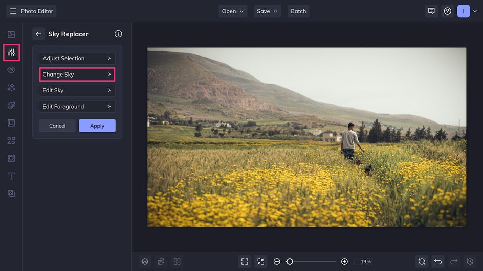 Sky replacer UI showing original photo of person in a field with cinematic effect in progress