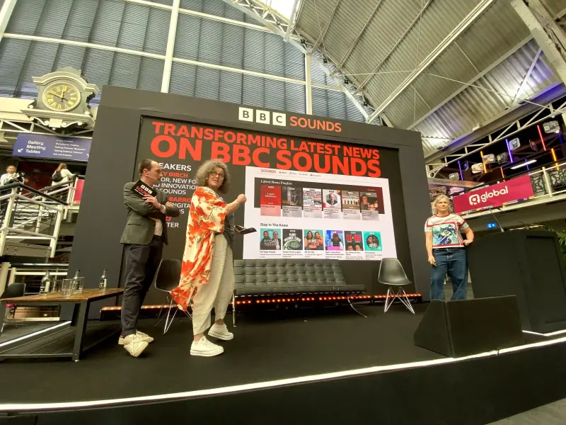 BBC News senior journalist Owen TJ, digital audio news editor Laura Barrow and BBC Sounds new formats and innovation editor Nicky Birch appear on stage at the 2024 Podcast Show where they discuss how the corporation has been introducing news content into BBC Sounds at the urging of press regulator Ofcom. Picture: Press Gazette