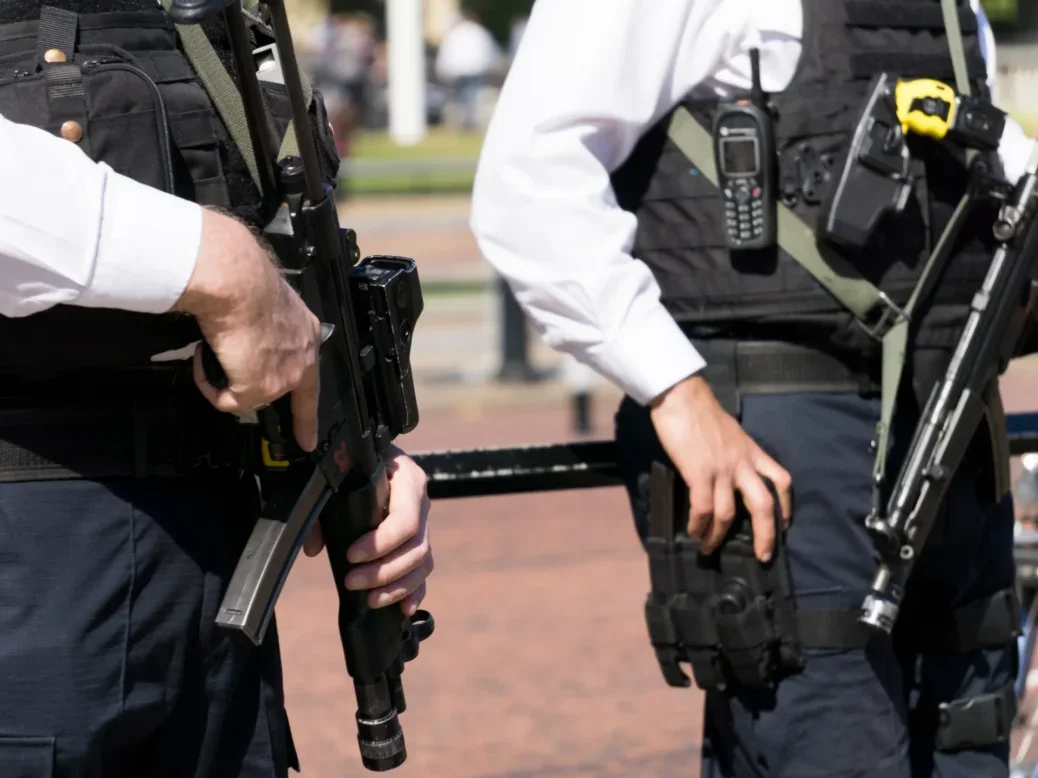 Armed metropolitan police officers are seen on the streets of London, cropped to hide their faces. The image illustrates a story about warnings from the Society of Editors and the Crime Reporters Association that new plans for a presumption of anonymity for firearms officers charged with a crime in the line of duty threaten to undermine the principle of open justice.